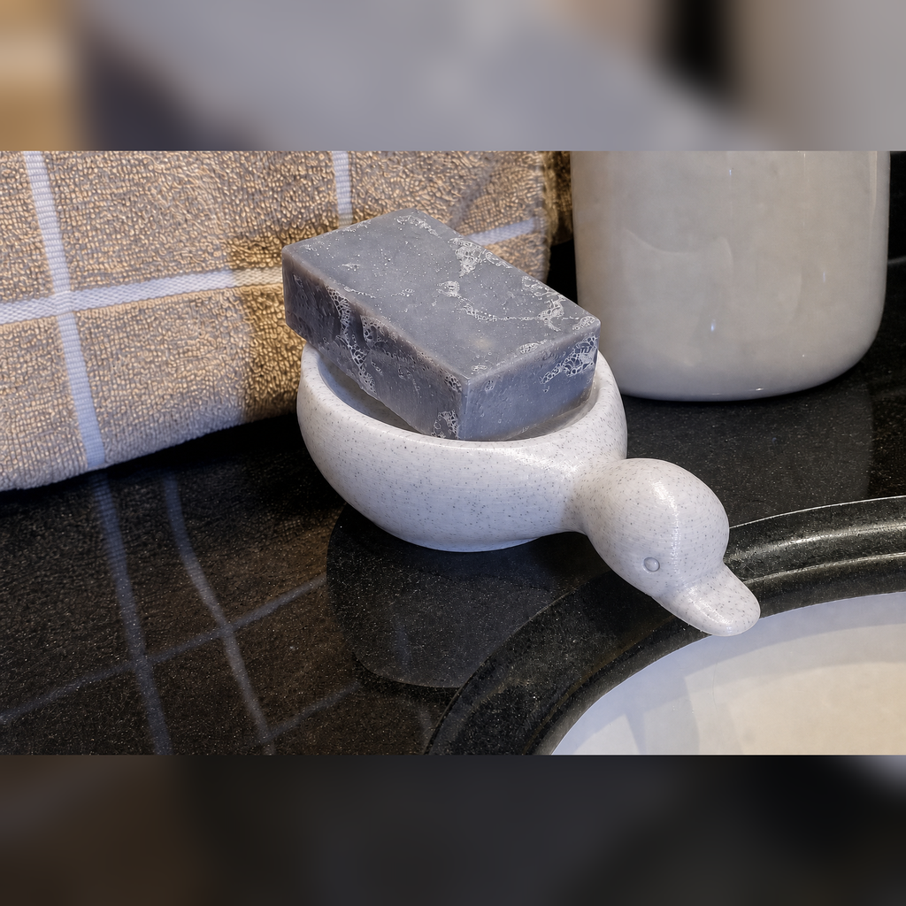 Marble-white duck soap dish on a bathroom counter with a bar of soap