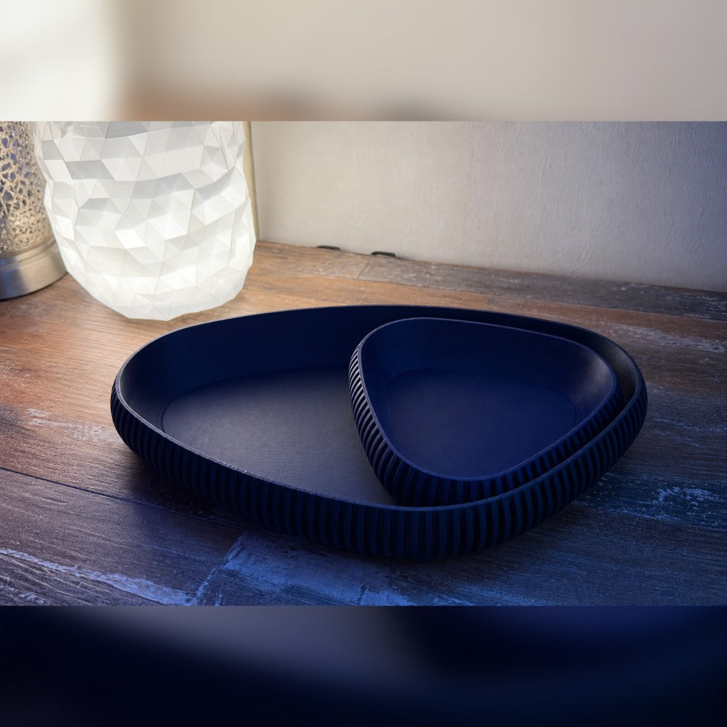 Nesting ribbed trays in dark blue on a warm wood table